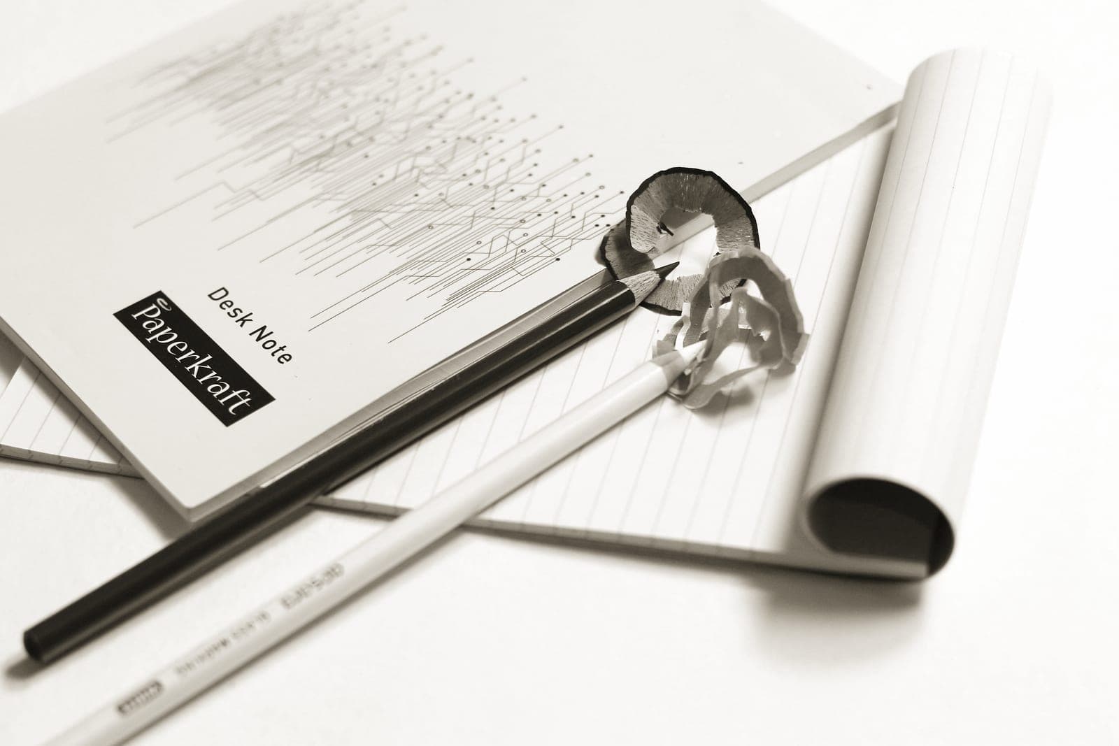 A notebook and pencil on a desk