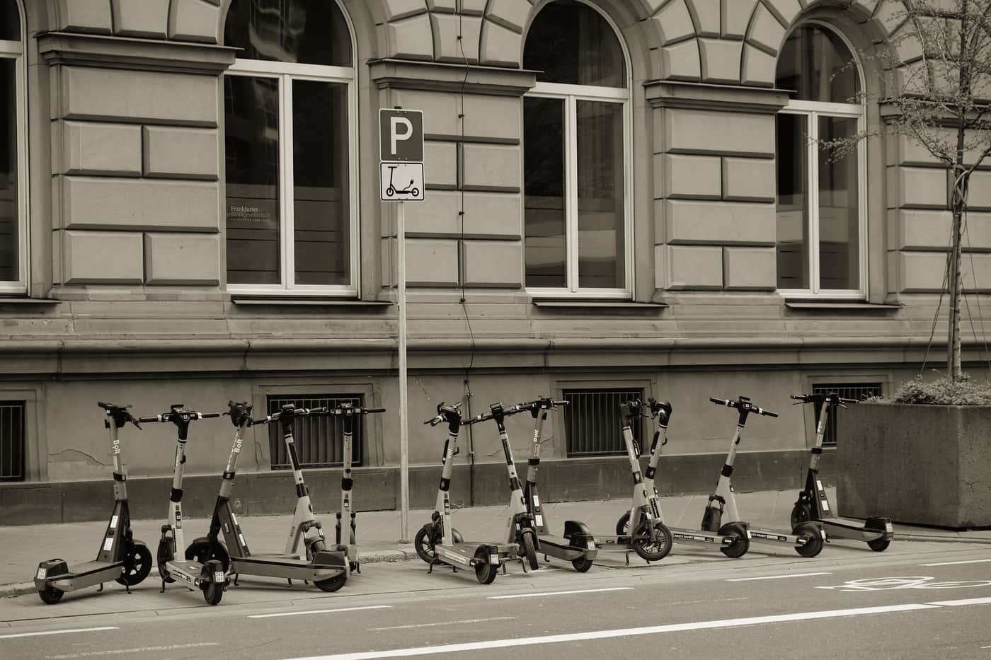 An electric scooter parked on a city bike lane at street level